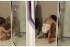 During A Storm, A Toddler Cuddles A Golden Retriever