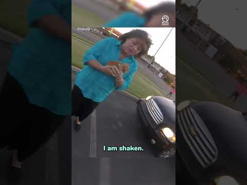 Woman Biker Saves Kitten Stranded On Road Inches Away From Being Hit By Passing Cars